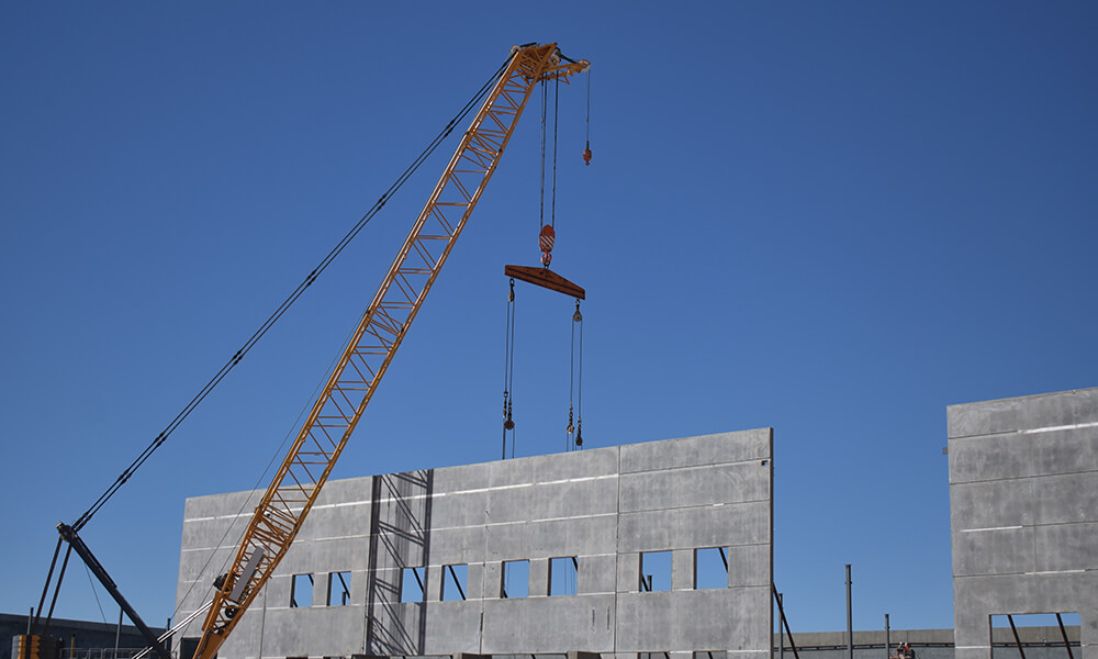 crane hoisting a wall